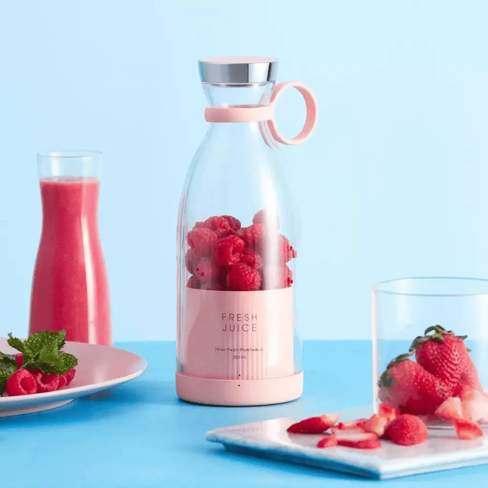 Presse agrume design Fresh Juice portable avec moteur électrique intégré.